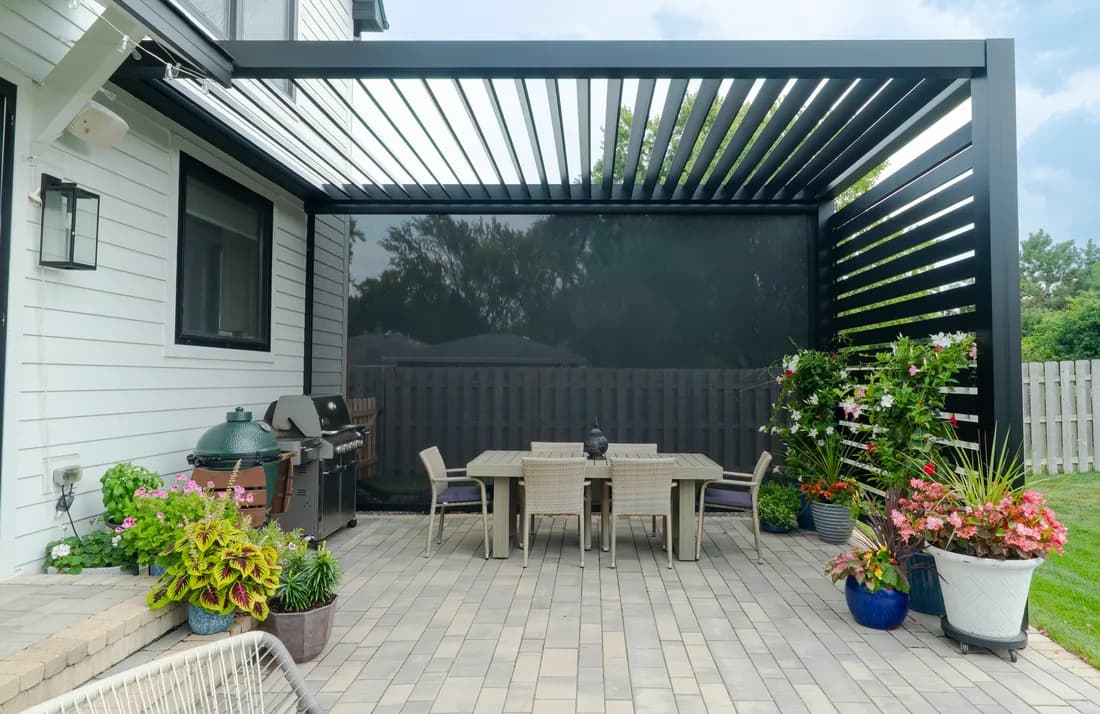 Azenco Outdoor R-BREEZE fixed-louver pergola with privacy screens lowered