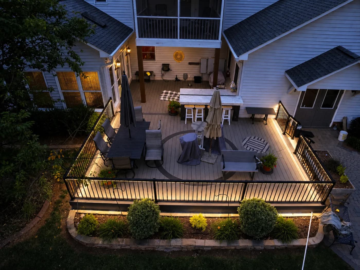 Deck and landscape illuminated with low-voltage outdoor lighting at dusk in Charlotte, NC